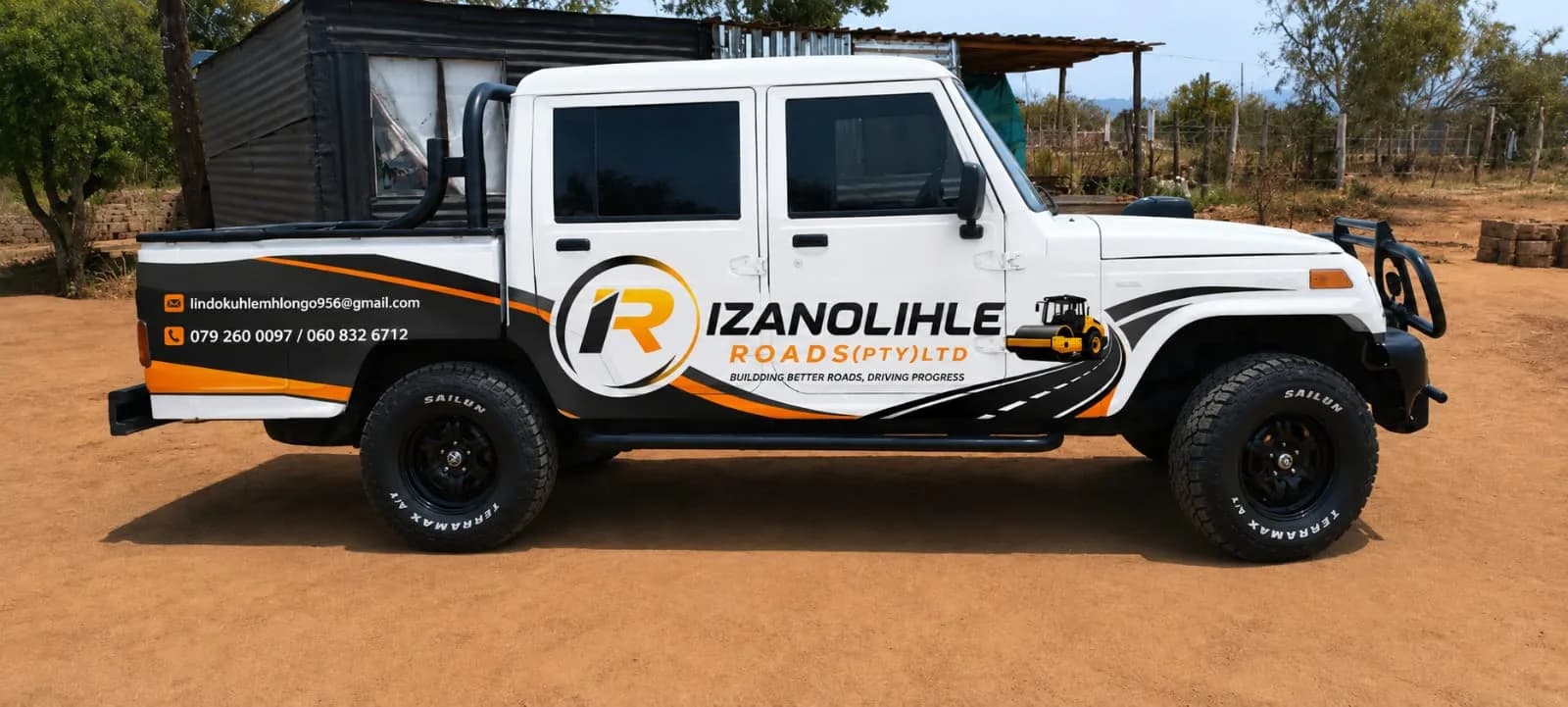 A 4x4 double-cab bakkie in full Izanolihle Roads livery.