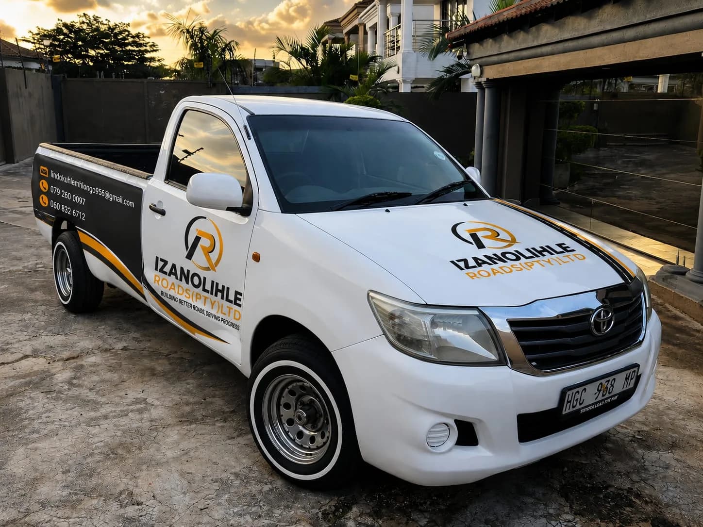 A Toyota Hilux single-cab bakkie in full Izanolihle Roads livery.