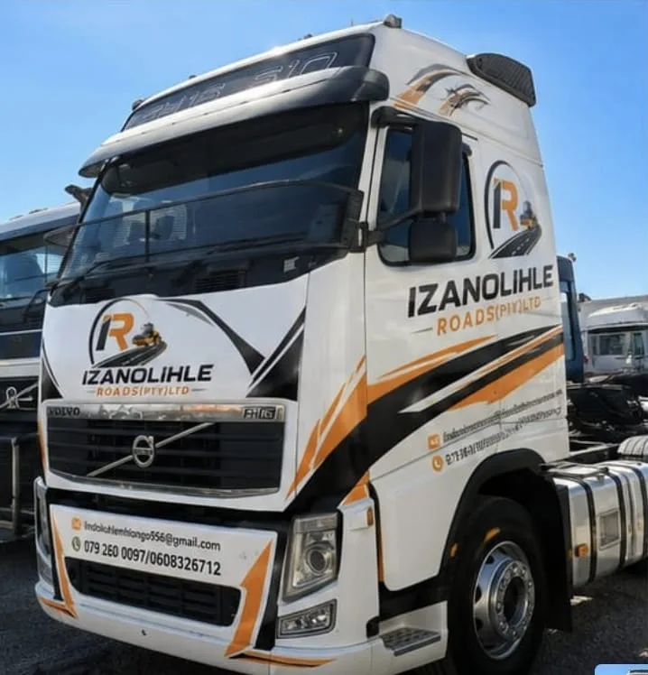 A Volvo FH16 610 truck-tractor in full Izanolihle Roads livery, coupled to a side-tipper trailer.