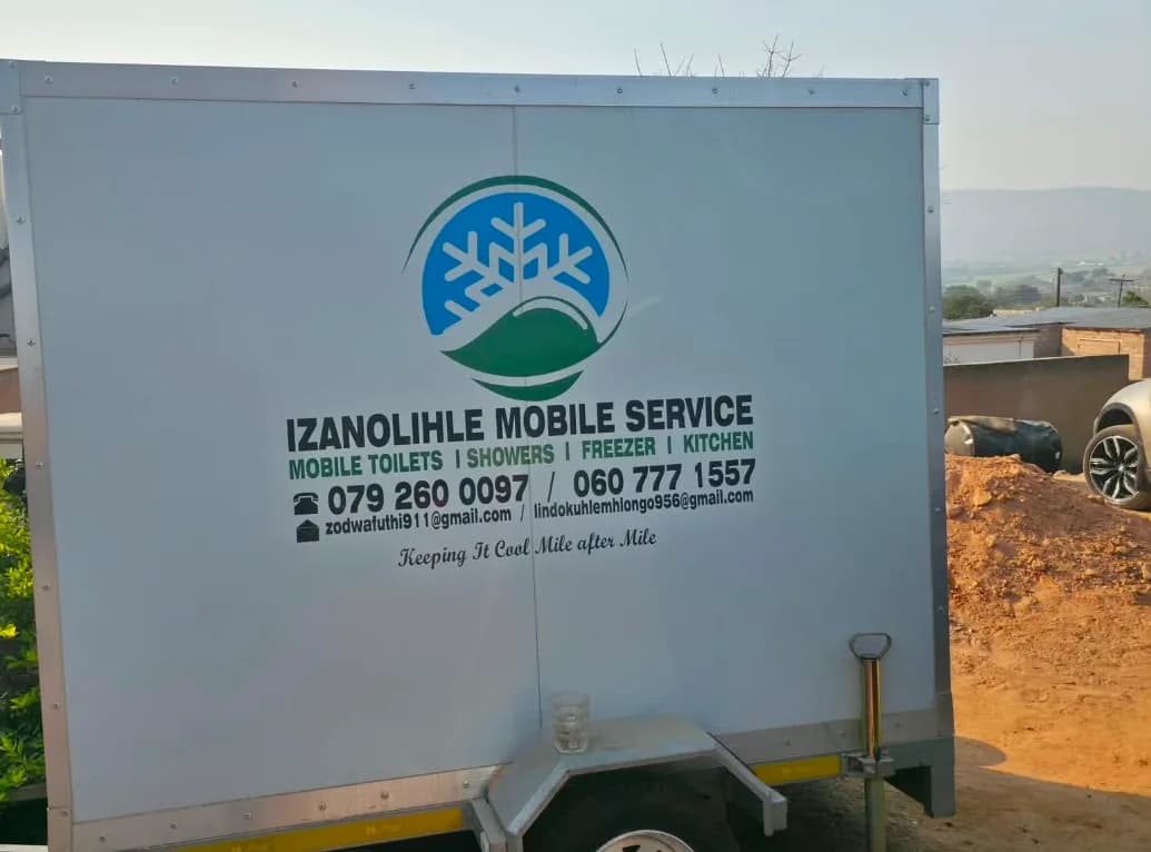 An Izanolihle Mobile Service trailer — mobile toilets, showers, freezer and kitchen.