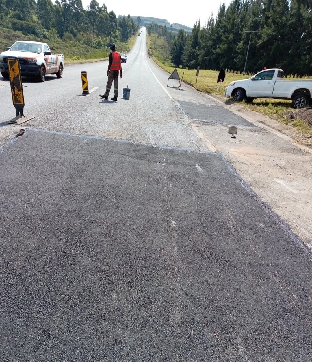 The finished repair — a flush, clean-edged patch with the road open.
